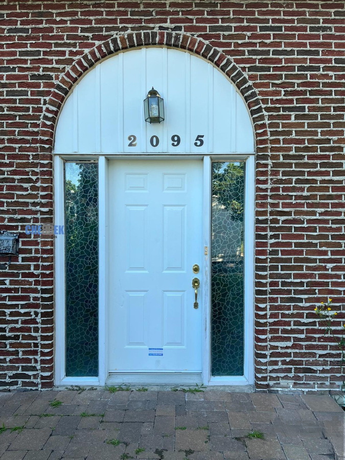 Arched entry door before renovation